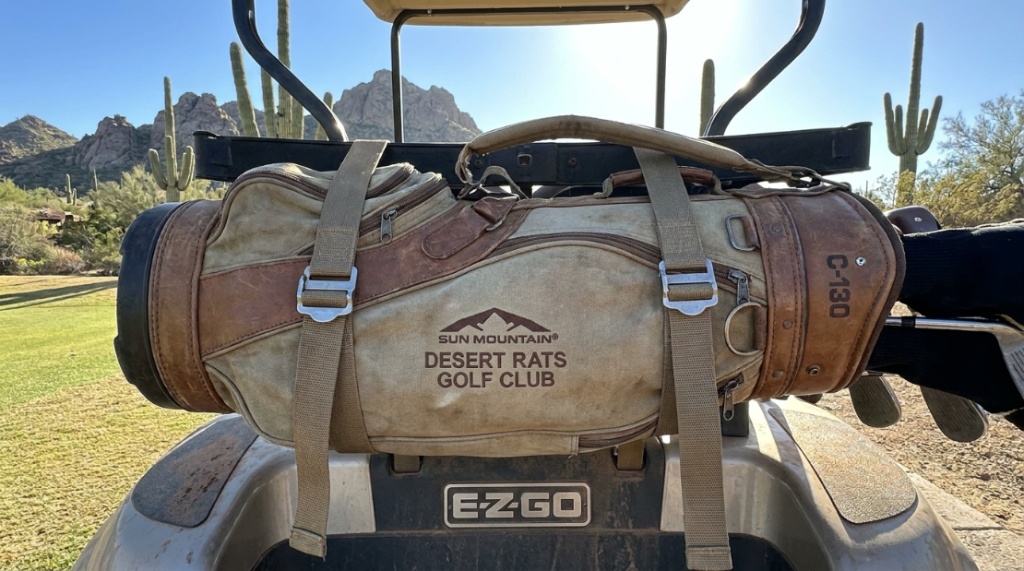 Secure golf cart bag strapped onto a cart on a sunny Arizona course.